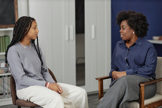 Young African woman talking with a counsellor in a calm room
