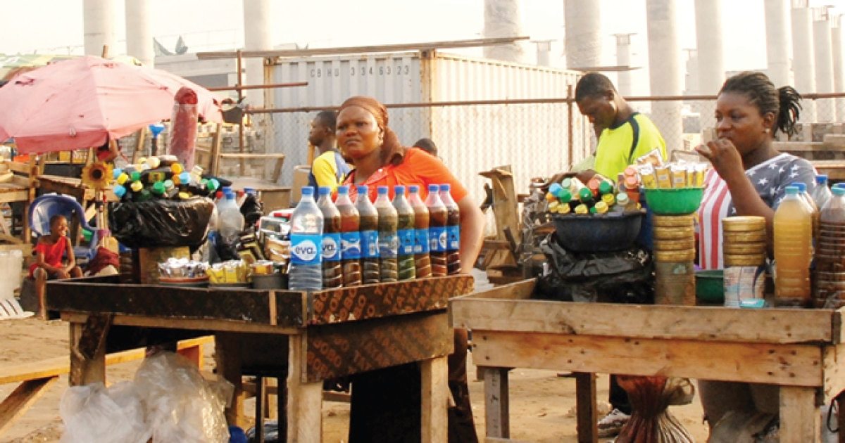 Bottles of herbal mixtures for sale at a Nigerian market stall